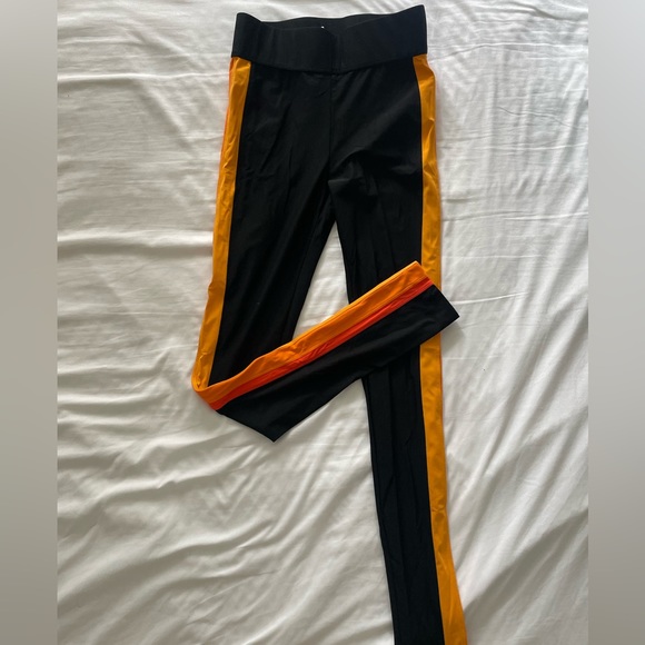 No Ka Oi black leggings with an orange striped detailing on the sides. - Picture 1 of 2